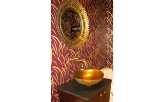 A deep wall color in a dark powder room adds depth and drama. Powder Room designed by Barbara Sternau Interior Design.