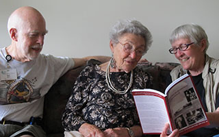 Ray and Anne Smith read Wartimes Remembered to Annette Finestone, an author of a story in the book, who has slight visual impairment.