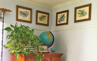 This collection of airplane prints in a young boy’s bedroom was highlighted by adding a thin piece of architectural molding just below the prints. The photos and molding both continue around the entire room.