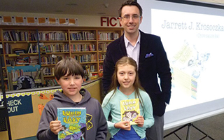 Students Kevin Demilla and Paige Mischenko with author Jarrett Krosoczka.