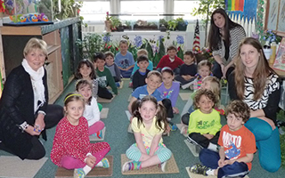 Todd Elementary School social worker Kay Brancato (left) with teacher Christina Hurley (back, right) and her kindergarten class and teacher assistant Sarah Weller in the school’s Mindful Garden, where youngsters come to share their thoughts and ideas in a unique and extra comforting environment.