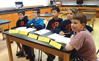 Pictured from left are Briarcliff Middle School sixth-graders Daniel de Castro, Kevin Mani, Chris Li, Matthew Sturman and Michael Donoghue participating in a Pace University STEM-D conference via Skype.