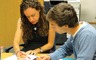 English teacher Samantha Fishman works with  Briarcliff High School Senior David Kaminsky on a  college essay in the school’s writing lab.