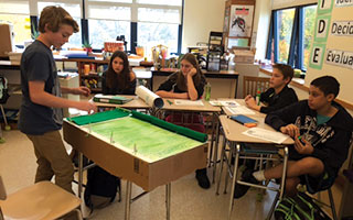 An eighth grader presents his idea to the “Shark Tank.”