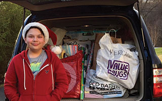 Briarcliff High School student Andrew Sugrue with the gifts he collected for Neighbors Link.