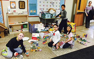 Dows Lane students sort donations to a local animal shelter  as part of December's celebration of “Dows Day.”