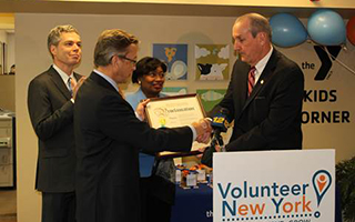 Mark Rollins, Volunteer New York! Board Chair, receives proclamation from Deputy County Executive, Kevin Plunkett, while White Plains Mayor Tom Roach and Senator Andrea Stewart-Cousins watch on.  Photo Credit: Volunteer New York!