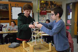 Irvington Middle School eighth-graders Henry Demarest and Nicholas Papapanou prepare their structure before its stability is tested in a simulated seismic event.