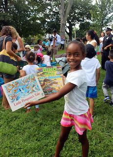 Six-year-old Eden Woodley shows off the books she chose at the Ossining Bookmobile event in Nelson Sitting Park.