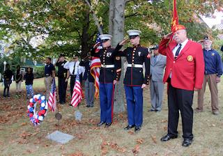 Veterans and members of the military salute during the ceremony for Craig Wyche at Ossining High School.