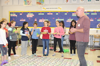 Game designer David L. Hoyt demonstrated the power of words to a group of sixth graders at Sleepy Hollow Middle School.