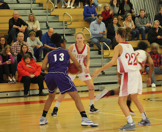 Sara Laub and Sophia Meyer go on the defense against the Lincoln Lancers at the Howard Godwin Holiday Basketball Tournament.