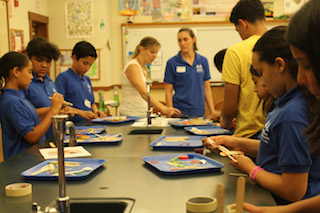 Hudson River Scholars and mentors enjoy a hands-on science class building catapults.