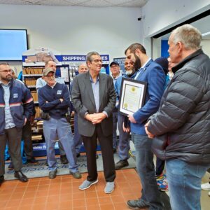 Briarcliff Manor Mayor Steven Vescio presents Anthony Arturi with a proclamation in his honor at the Pleasantville Road post office on Jan. 6, 2025. Photo by Robert Brum