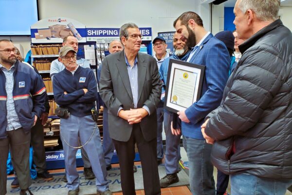 Briarcliff Manor Mayor Steven Vescio presents Anthony Arturi with a proclamation in his honor at the Pleasantville Road post office on Jan. 6, 2025. Photo by Robert Brum